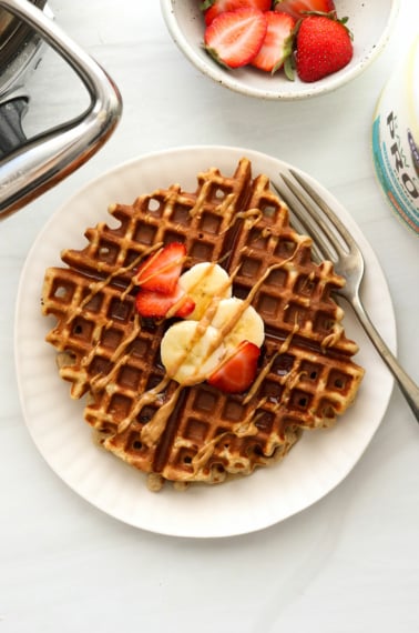 protein waffle topped with fruit and peanut butter.